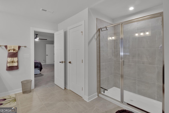 bathroom with an enclosed shower and tile patterned floors