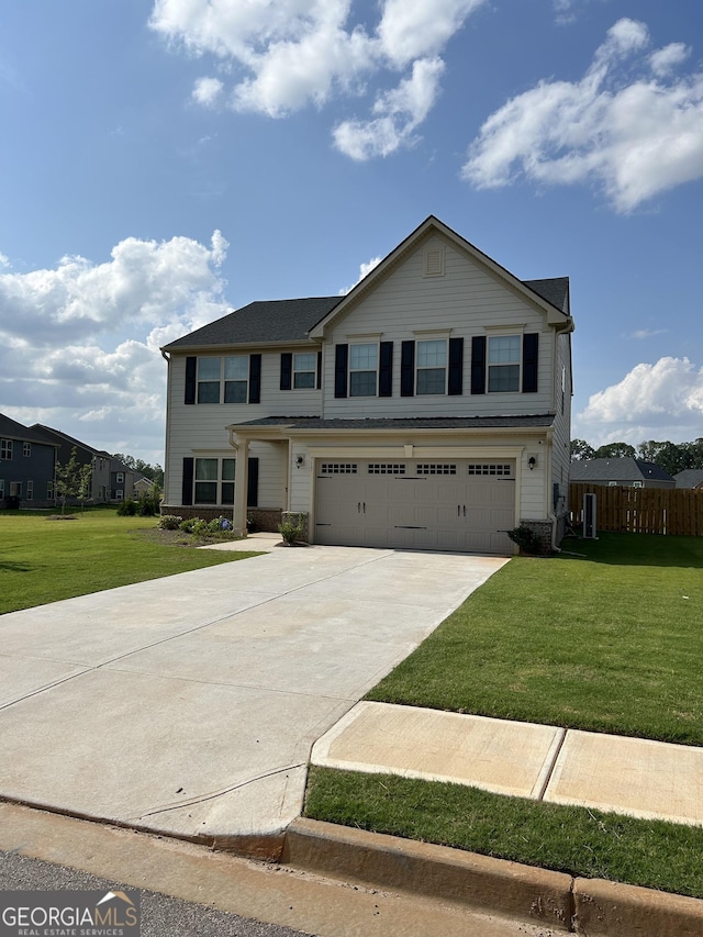 view of front of home with a garage and a front lawn