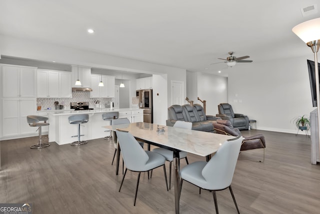 dining room with wood-type flooring and ceiling fan