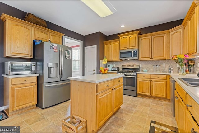 kitchen featuring decorative backsplash, stainless steel appliances, and a kitchen island