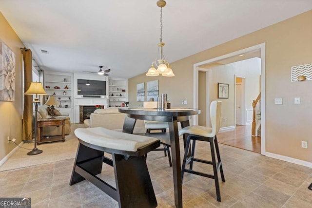 dining room with ceiling fan and built in features