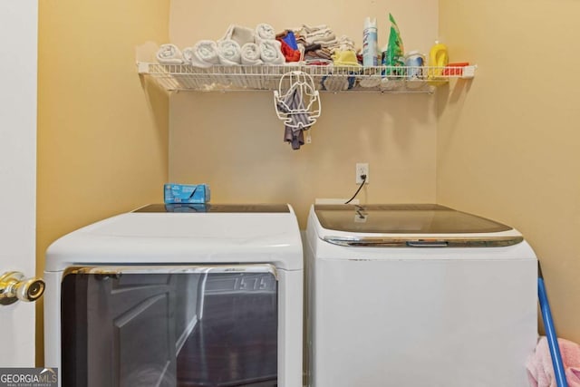 clothes washing area featuring washer and clothes dryer