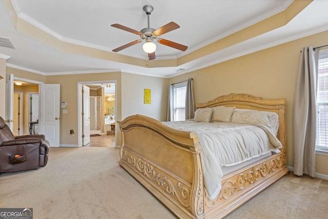 carpeted bedroom with multiple windows, a tray ceiling, and crown molding