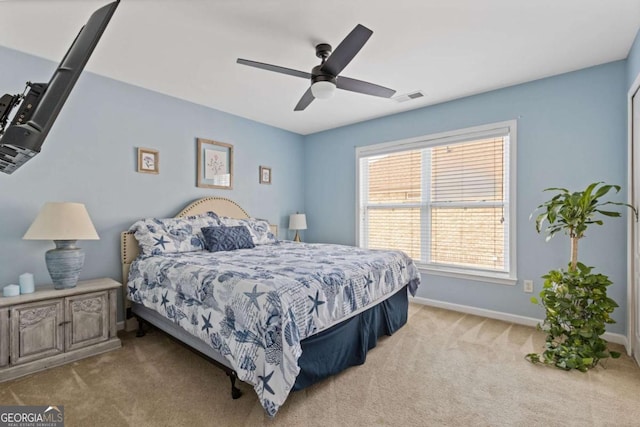 bedroom featuring ceiling fan and light carpet