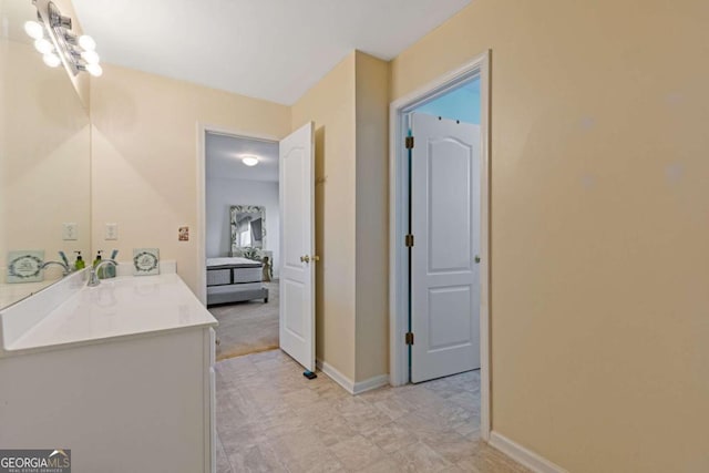 bathroom with an inviting chandelier and vanity