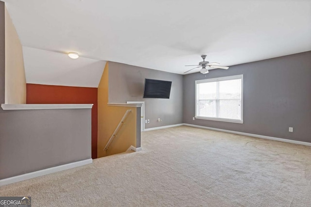 interior space featuring ceiling fan and light colored carpet