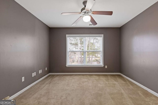 carpeted empty room featuring ceiling fan