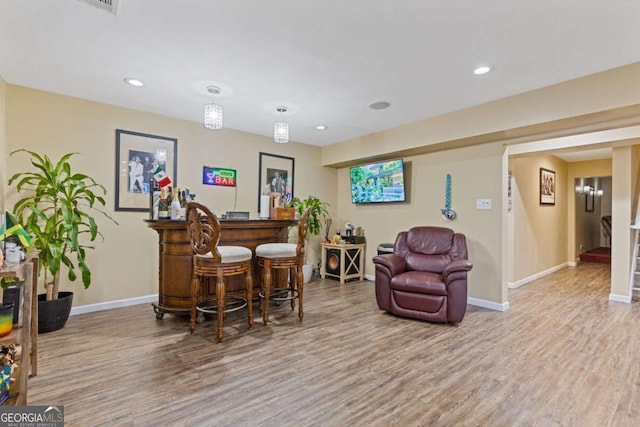 bar featuring hardwood / wood-style flooring