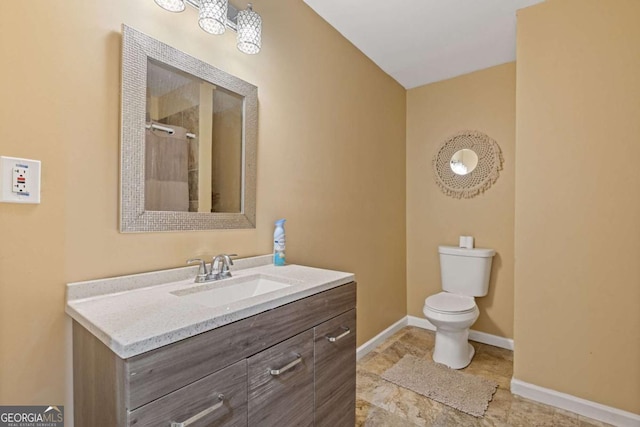 bathroom with vanity, walk in shower, and toilet