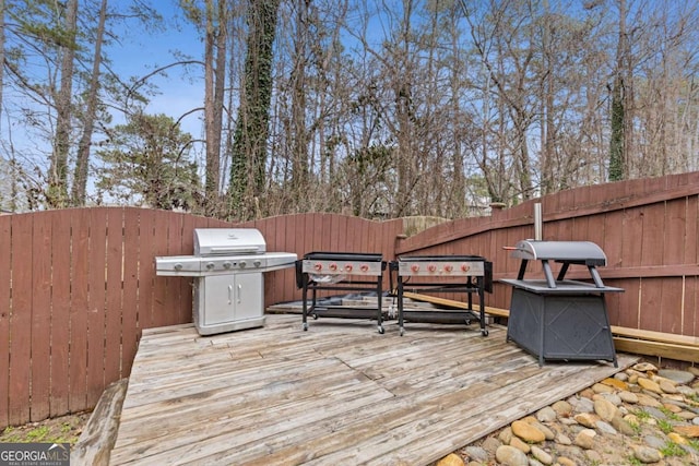 wooden terrace featuring a grill