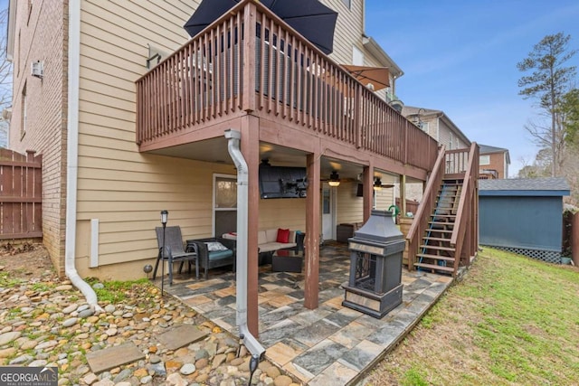 rear view of house featuring a wooden deck and a patio area