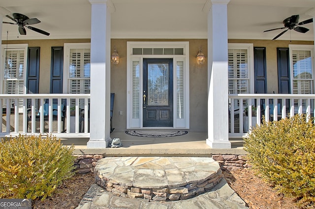 property entrance featuring ceiling fan and a porch