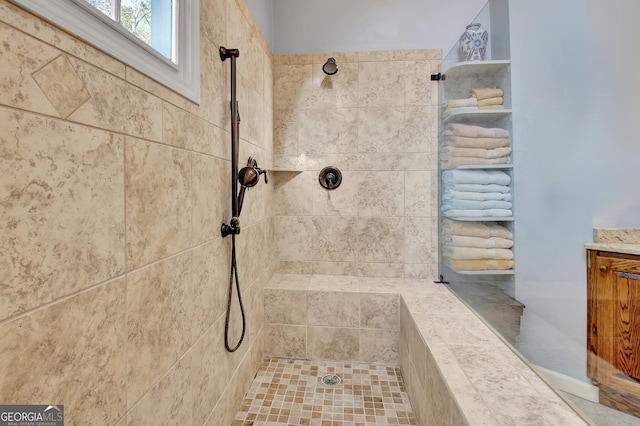 bathroom with tiled shower