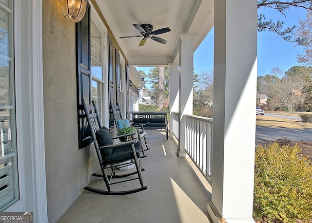 balcony featuring ceiling fan and a porch