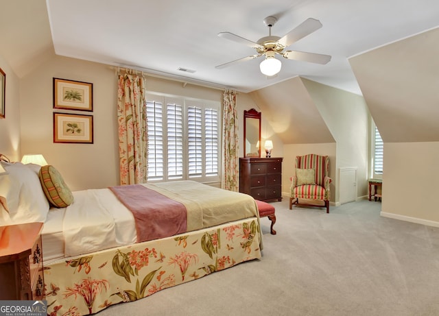 carpeted bedroom with vaulted ceiling and ceiling fan