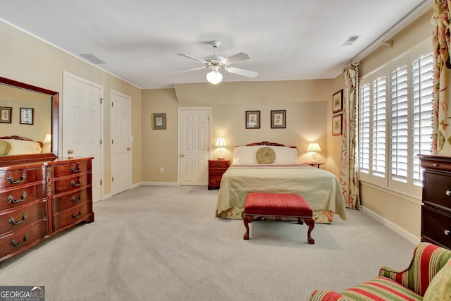 bedroom featuring light colored carpet and ceiling fan