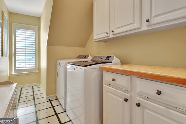 laundry area with cabinets and separate washer and dryer