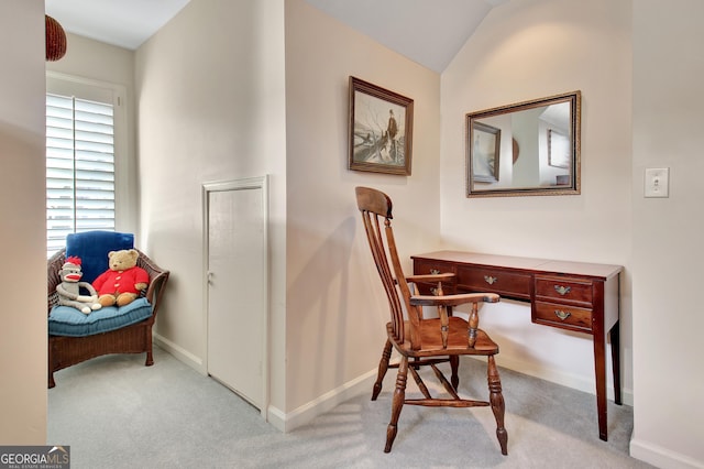 carpeted office featuring vaulted ceiling