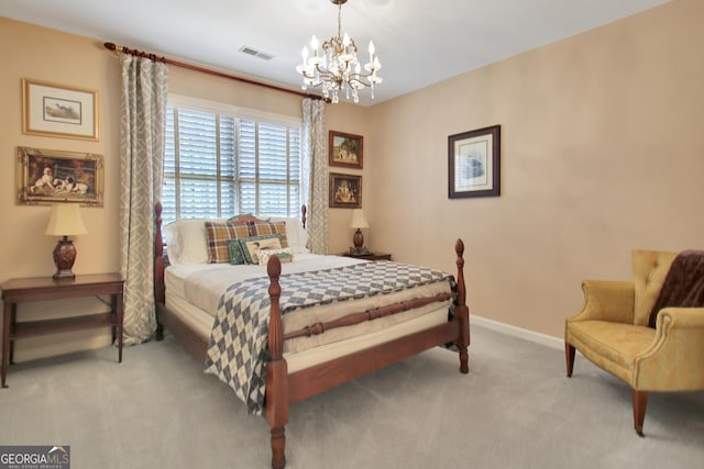 carpeted bedroom featuring an inviting chandelier