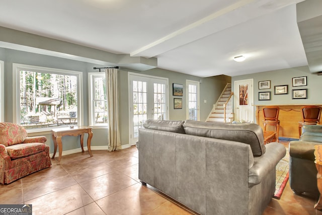 living room with beam ceiling, plenty of natural light, and light tile patterned flooring