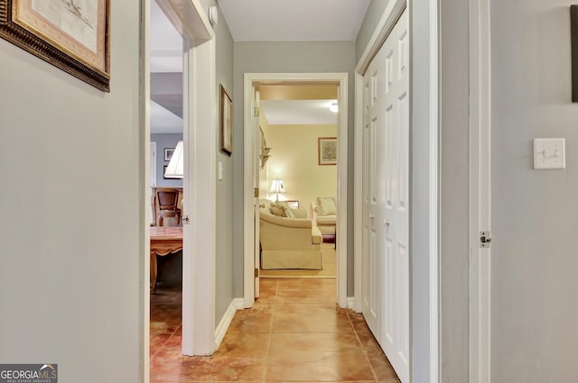 hall featuring light tile patterned floors