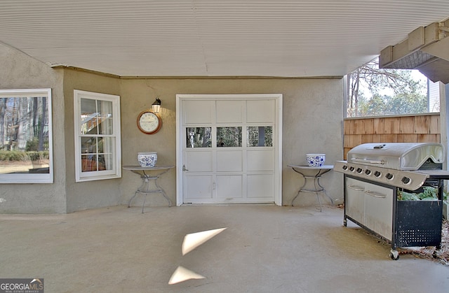 view of patio featuring a garage and grilling area