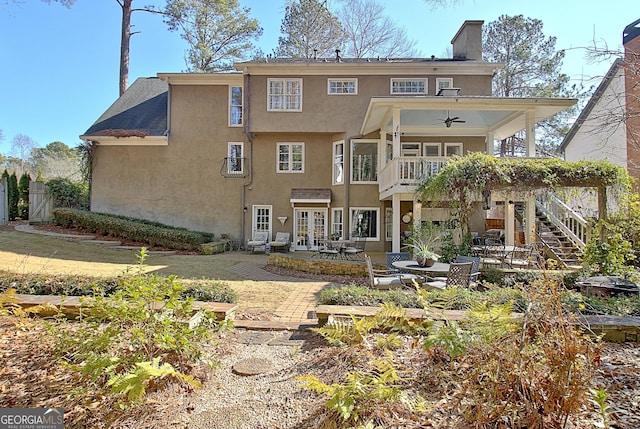 back of property with a patio area, a balcony, and ceiling fan