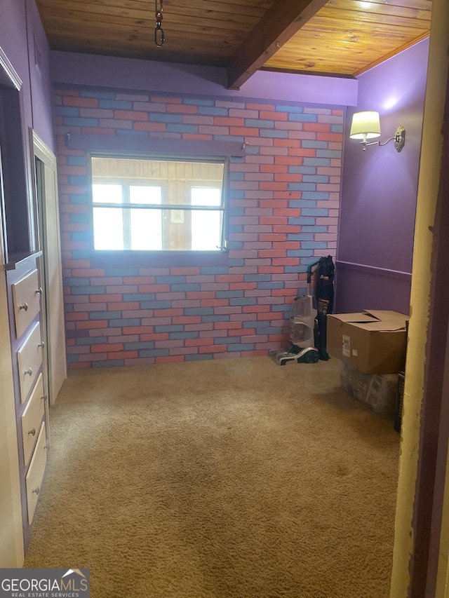 interior space with wood ceiling, brick wall, and carpet