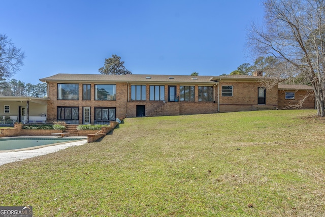 185 E Lakeview Dr NE, Milledgeville, GA 31061 - back of house with brick siding and a yard