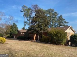 view of property exterior with a yard