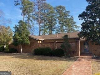 single story home with a front lawn and brick siding