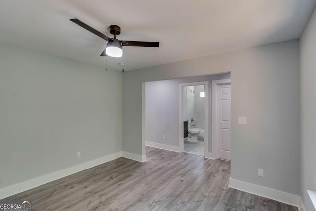 spare room featuring ceiling fan and light hardwood / wood-style floors