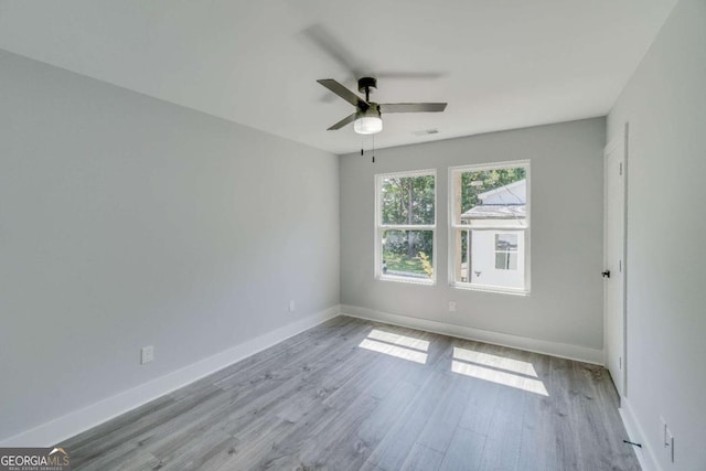 empty room with ceiling fan and light wood-type flooring