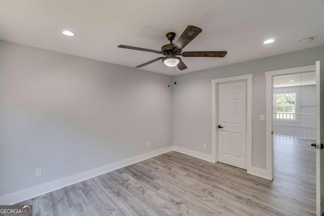 spare room with light hardwood / wood-style flooring and ceiling fan