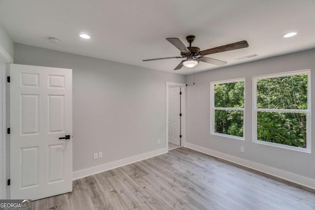 spare room with ceiling fan and light hardwood / wood-style flooring