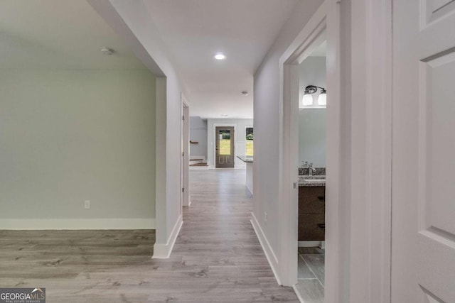 hall with light hardwood / wood-style flooring