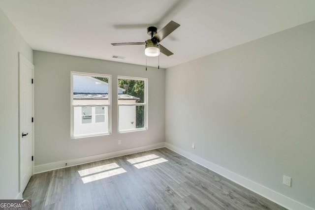 unfurnished room featuring ceiling fan and light wood-type flooring