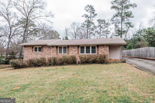 ranch-style home with a front lawn