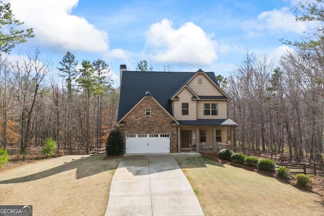 view of front facade with a garage, a front lawn, and covered porch