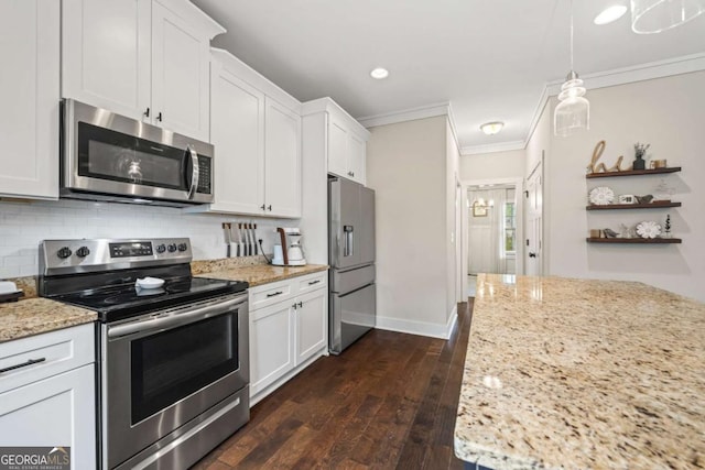 kitchen featuring white cabinetry, appliances with stainless steel finishes, and decorative light fixtures