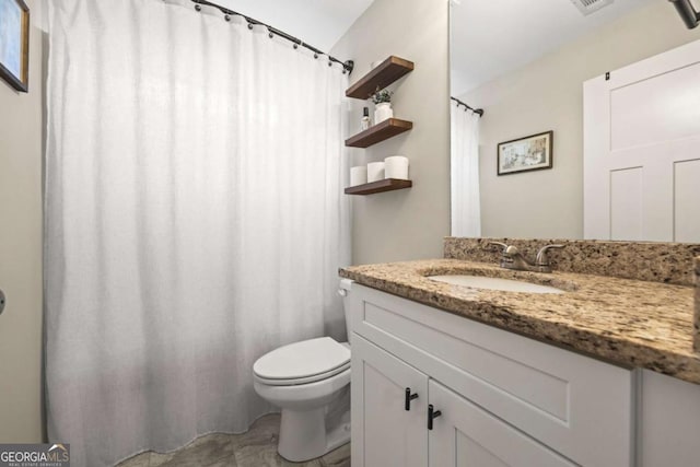 bathroom with vanity and toilet