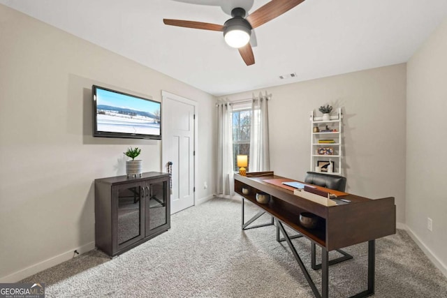 carpeted office with ceiling fan