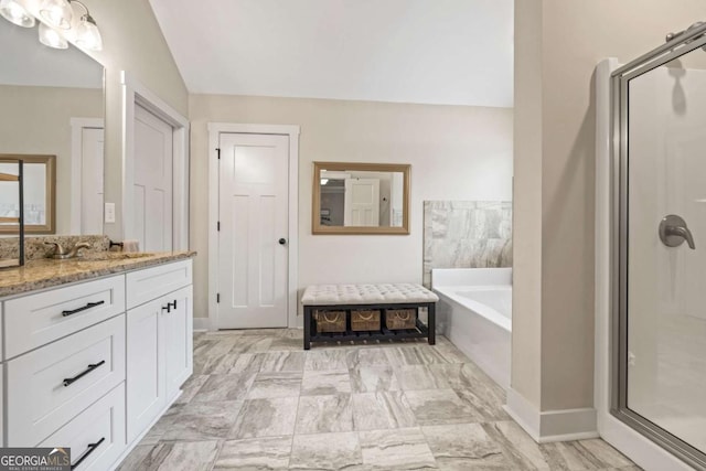 bathroom featuring vanity, separate shower and tub, and vaulted ceiling