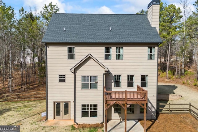 back of house with a wooden deck and a patio area