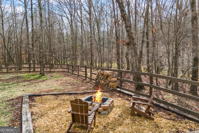 view of yard with a fire pit