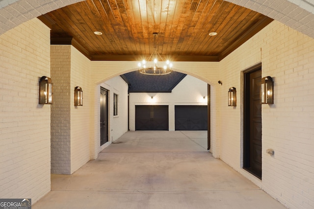 hall featuring an inviting chandelier