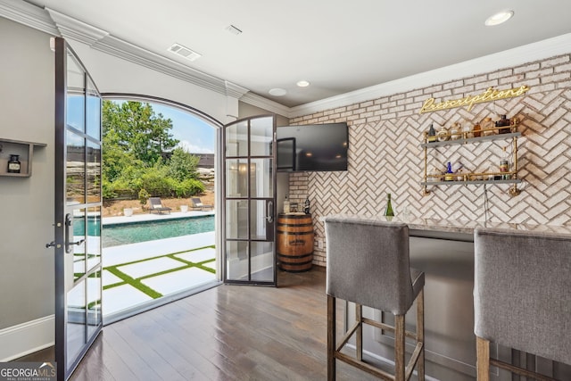 kitchen featuring dark wood finished floors, crown molding, recessed lighting, light countertops, and visible vents