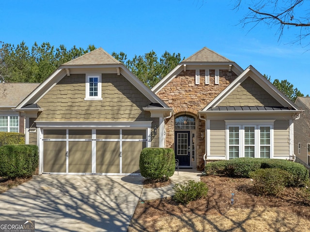 craftsman house featuring stone siding and concrete driveway