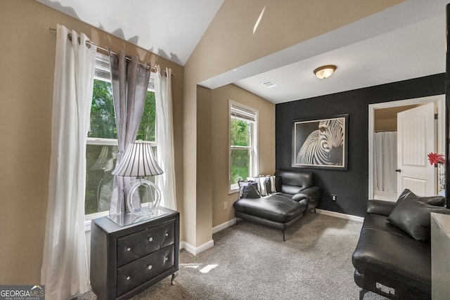 living area with lofted ceiling and carpet flooring