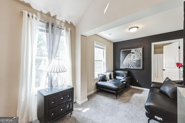 living area with lofted ceiling and carpet